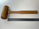 Wooden mallet with a visible brand name on a white background, accompanied by a ruler for scale.