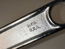 Metal wrench with 'MFD. U.S.A.' engraving on a gray background