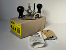 Vintage Stanley router plane on a cardboard box with packaging materials on a white background