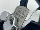 Close-up of a metal tool with 'Woden' branding on a blurred background