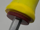 Close-up of a yellow and red object with 'FRANCE' text on a gray background