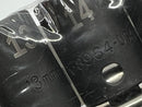 Close-up of a metal object with engraved numbers and measurements.
